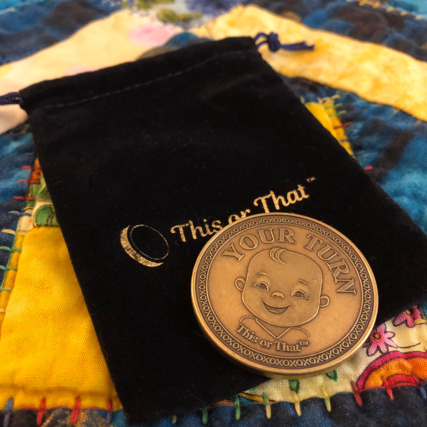 This or That Diaper Changing Coin with Velvet Pouch in bed